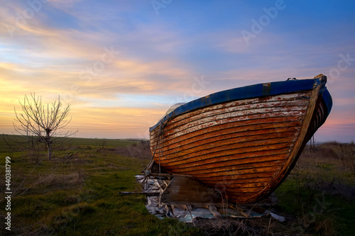 an old boat on an uncultivated field