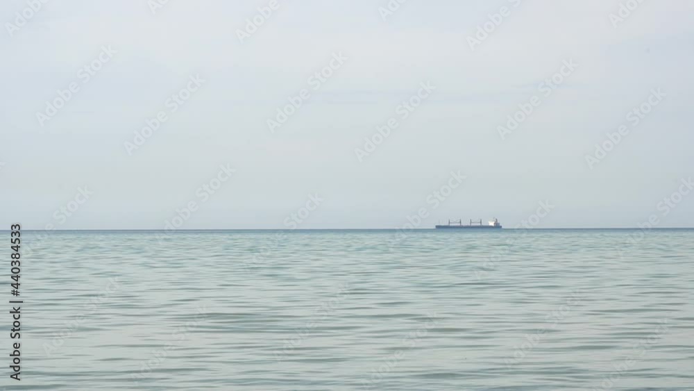 The ship is moving into the sea far on the horizon. High quality FullHD footage The ship is moving into the sea far on the horizon. High quality FullHD footage