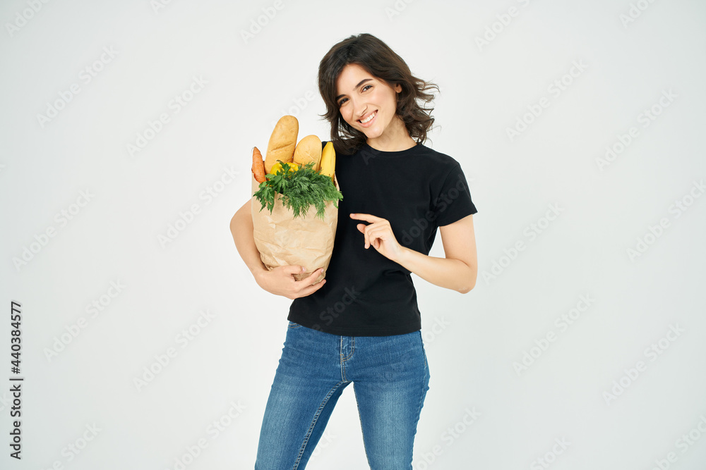 woman with a package of groceries shopping delivery to vegetables woman with a package of groceries shopping delivery to vegetables
