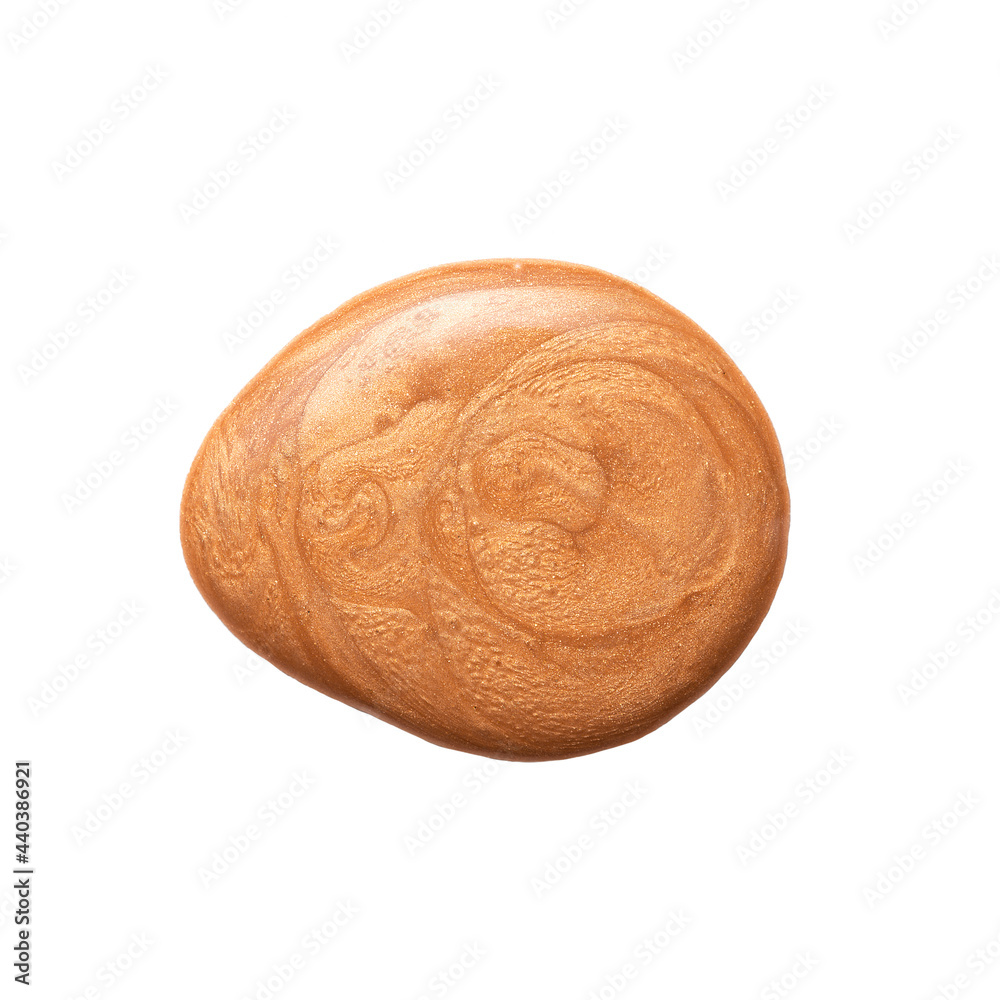 Drop of golden bronzer cream with abstract patterns for skin care and makeup isolated on white background close upper view.