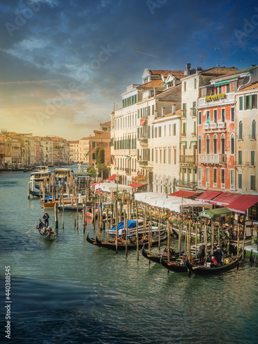 Beautiful sunrise in Venice, views of one of its famous canals crisscrossed by gondolas.