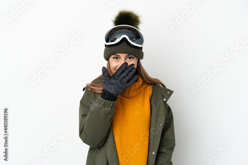 Skier caucasian woman with snowboarding glasses isolated on white background happy and smiling covering mouth with hand © luismolinero
