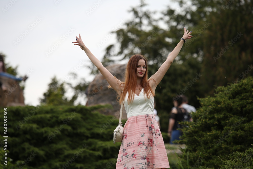 Woman in pink skirt walking outside
