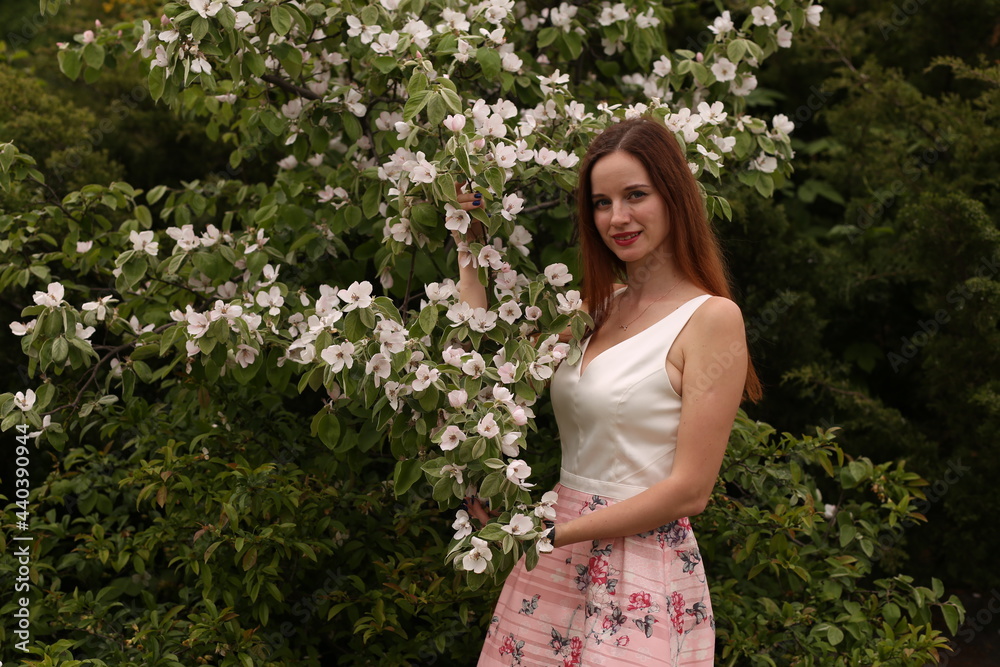 girl in a pink skirt near white flowers girl in a pink skirt near white flowers
