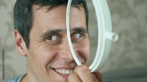 Man makes a funny face using a mirror
