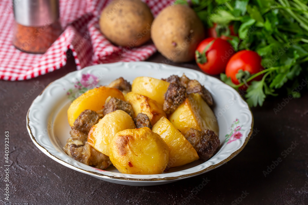 From traditional delicious Turkish food; potato and meat dish in casserole (Turkish name; Guvec tas kebabi)