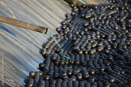 East Kazakhstan region, Kazakhstan - 12.02.2015 : The chemical tank is covered with plastic balls to slow evaporation at the copper cathode mining plant. © Vladimir