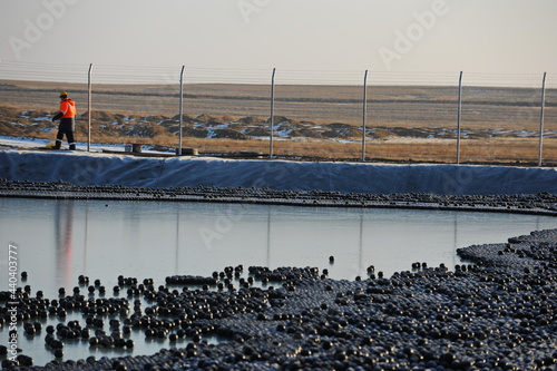 East Kazakhstan region, Kazakhstan - 12.02.2015 : The chemical tank is covered with plastic balls to slow evaporation at the copper cathode mining plant. photo