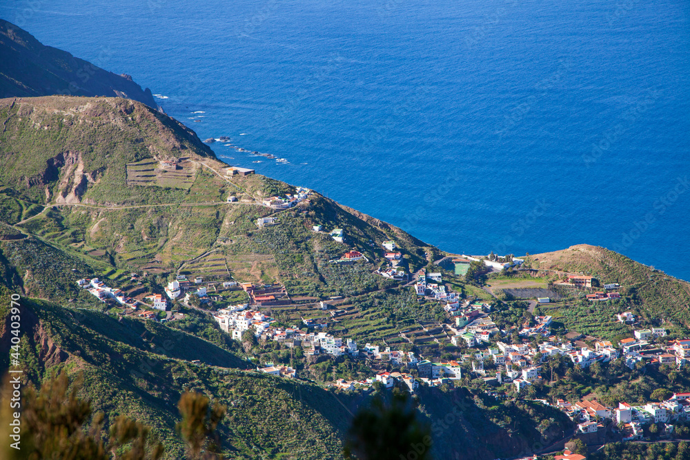 Beautiful summer view of the cliffs, small town and the Atlantic Ocean from the high point of the island of Tenerife (Canary Islands)