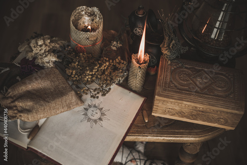 Magical attribute on a table, witchcraft concept, Candle fire, Spells and other rituals photo