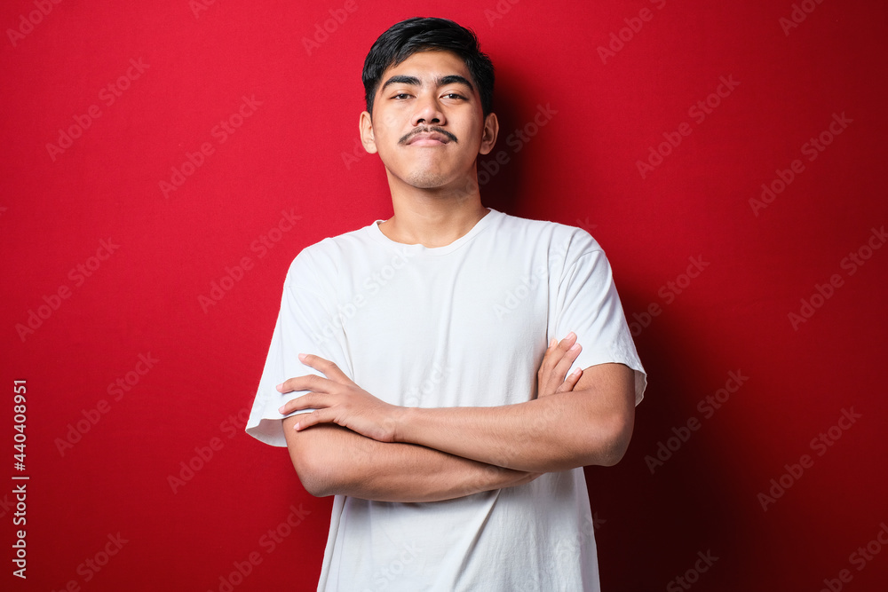 Young handsome man wearing white tshirt happy face smiling with crossed arms looking at the camera. positive person. Young handsome man wearing white tshirt happy face smiling with crossed arms looking at the camera. positive person.