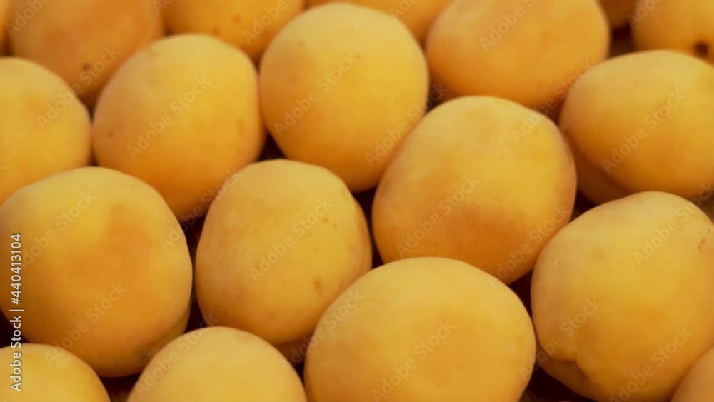 Ripe Apricots, Fruits, Close-up, Macro, Rotation, Isolated. A Fresh Crop Of Apricots. Apricots at the Market, Counter, Supermarket. Background of Apricots. Healthy Vegan Food and a Vegetarian Diet. Ripe Apricots, Fruits, Close-up, Macro, Rotation, Isolated. A Fresh Crop Of Apricots. Apricots at the Market, Counter, Supermarket. Background of Apricots. Healthy Vegan Food and a Vegetarian Diet.