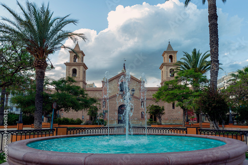 fountain in the plaza de la constitucion in Torrevieja, alicante and in front of the church of the immaculate conception.
