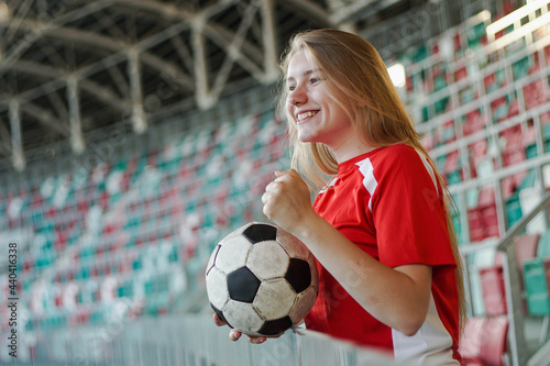 Portrait of excited female football fan watching soccer match at big stadium © glebcallfives