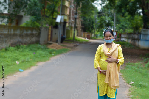 Young asian indian pregnant woman standing against outdoor.
