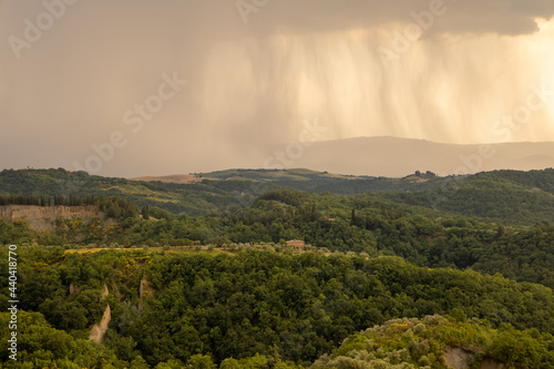 Beautiful idyllic summer landscape of Toscana, Italy during the rain. View through the window with heavy rain in Italy. Vacation, recreation mood. Agricultural fields of Tuscany 
