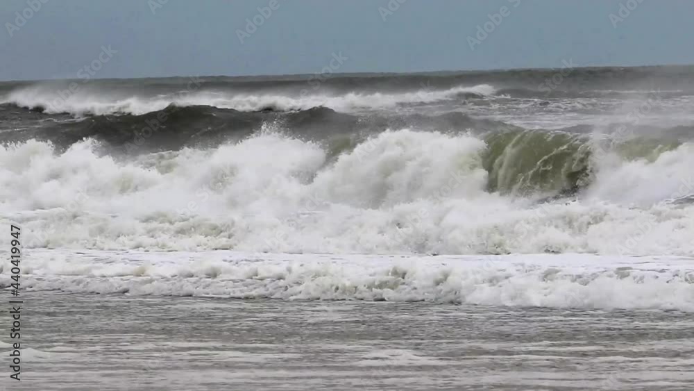 Rough ocean waves from a tropical storm with heavy winds blowing the water backwards and forming many dangerous waves. Rough ocean waves from a tropical storm with heavy winds blowing the water backwards and forming many dangerous waves.