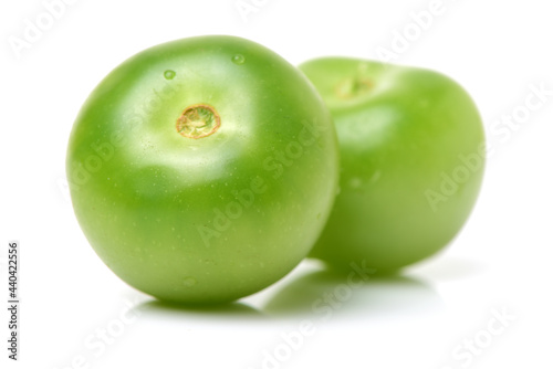 green tomatoes on white background