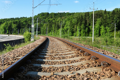 Railway tracks and beautiful mountain landscapes all around.