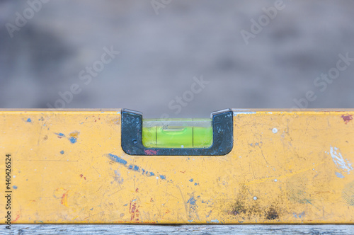 Yellow spirit level old on wood table
