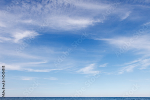 Fototapeta Naklejka Na Ścianę i Meble -  Beautiful blue sky over the sea with translucent, white, Cirrus clouds