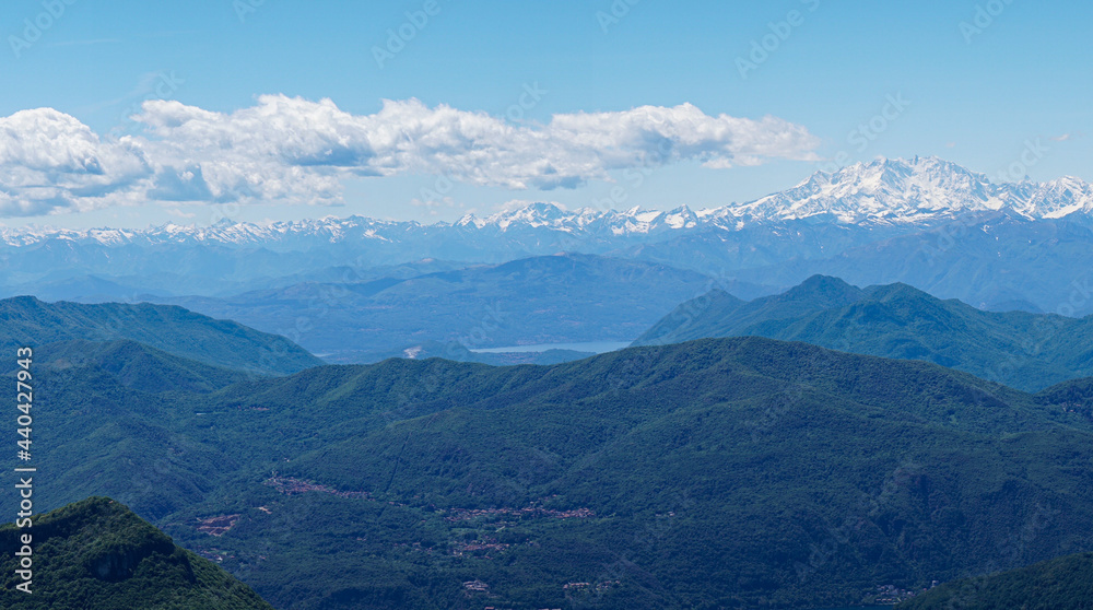 layers of mountains, view from Monte Generoso to the Swiss with snow on the top in summer