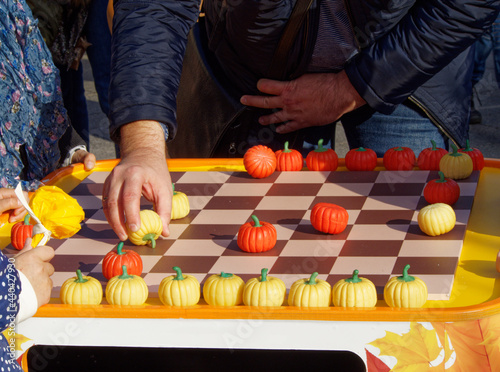 A hand holding a checker to make a move in Russian draughts