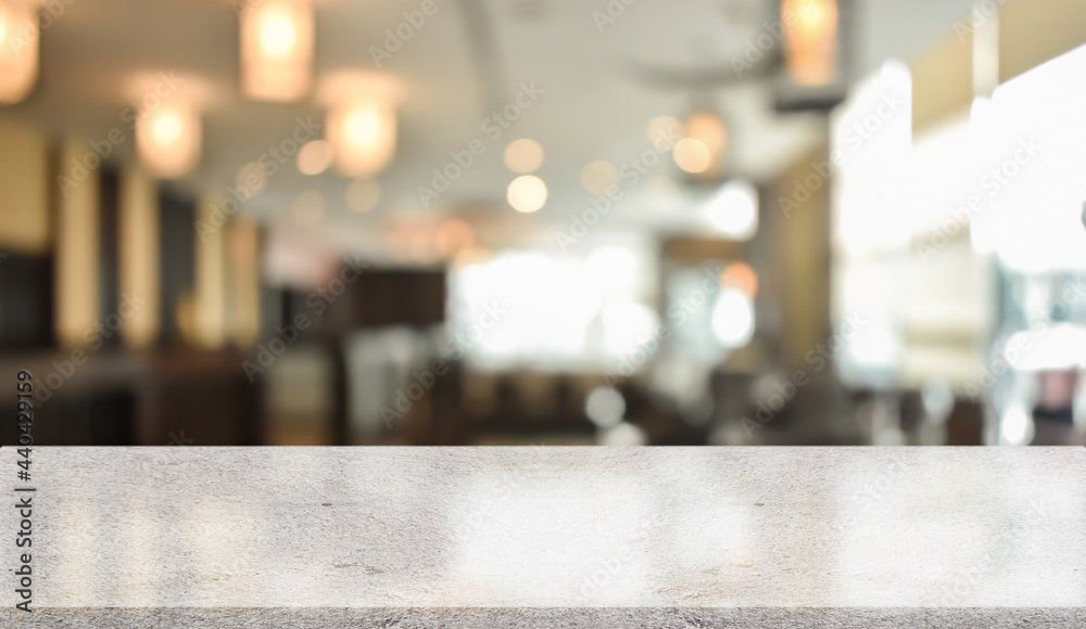 Empty white marble stone table top and blur interior cafe and restaurant.