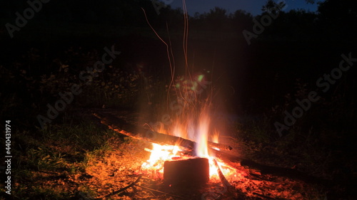 Night tourist campfire in a forest glade.
