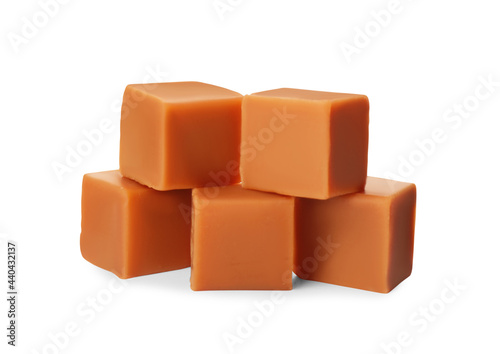 Heap of caramel candies on white background