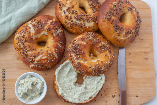 Freshly baked whole grain bagels. heap of fresh baked bagels on a table