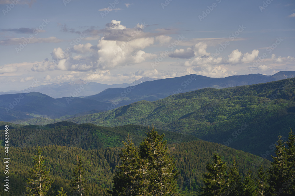Clouds over the mountains. Sunny day in the mountains. Ukrainian Carpathian mountains.