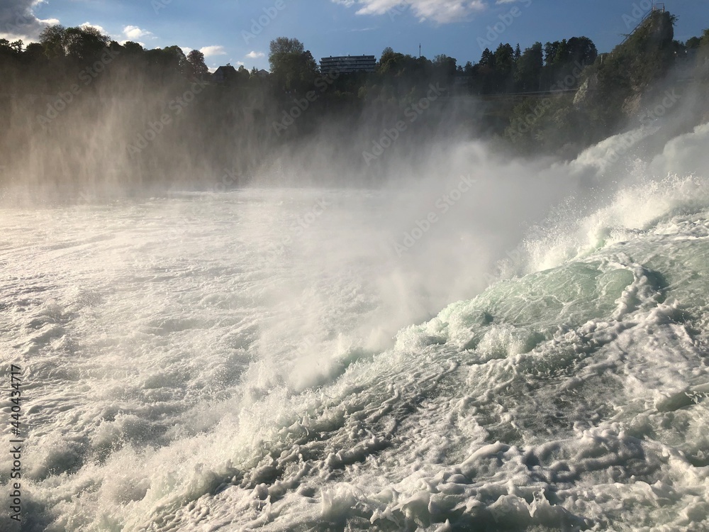 Obraz premium Splashing water at the incredible rhine falls in Switzerland 28.5.2021