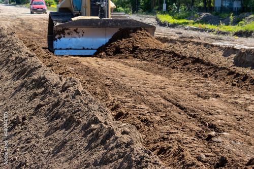 Construction site. Road repair. Removing soil with a bulldozer