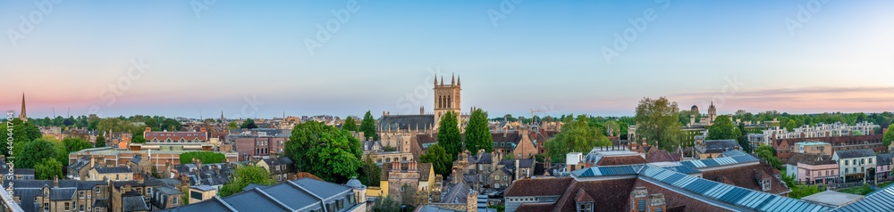 Cambridge city rooftop panorama overlooking tower of great St. Mary's church at sunset. England