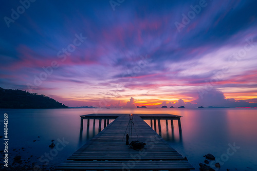 Fototapeta Naklejka Na Ścianę i Meble -  Long exposure landscape ,Pier of wood with a beautiful twilight sunset sky background, Dramatic purple sky , at Phangka beach koh samui thailand