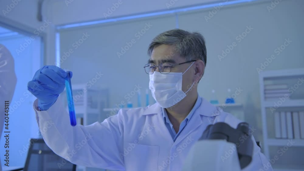 Research concept of 4k resolution. Asian scientists are comparing laboratory solutions. Research concept of 4k resolution. Asian scientists are comparing laboratory solutions.
