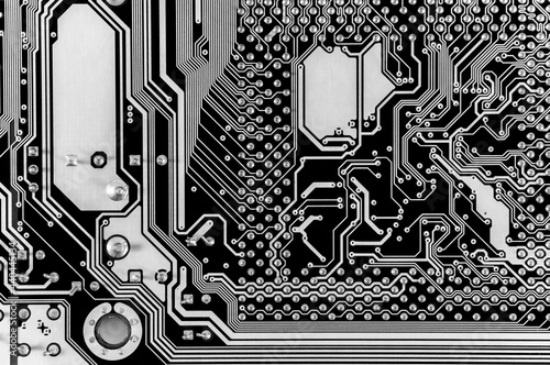 Black and white texture background of printed circuit board. Computer technology background. Information tech. Space for text. Gray scale pcb background.