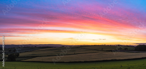 Sunset over fields in Berry Pomeroy Village, Devon, England, Europe