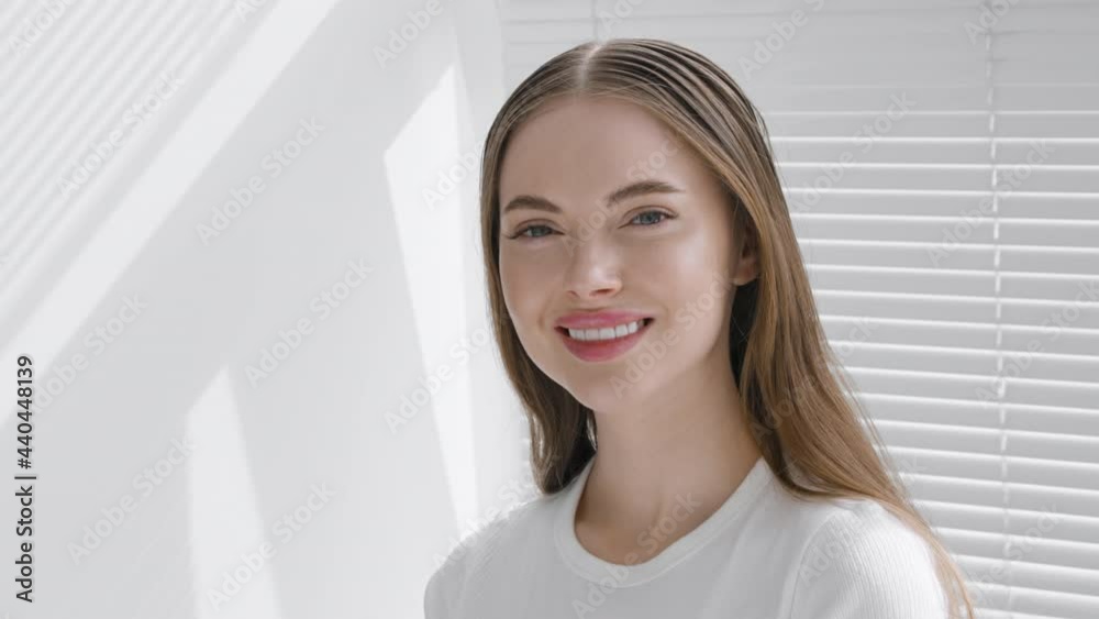 Beautiful young woman happy teeth smile face portrait looking camera, beautiful model with long brunette hair white color window Beautiful young woman happy teeth smile face portrait looking camera, beautiful model with long brunette hair white color window