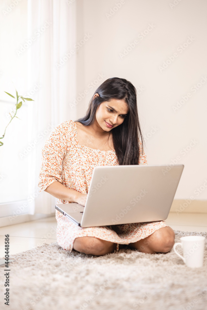 Indian pretty young girl using laptop at home Indian pretty young girl using laptop at home
