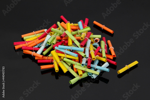 heap of colorful tombola tickets on a black ground photo