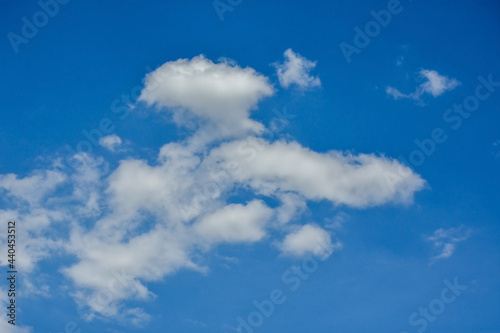 Beautiful cumulus clouds against the blue daytime sky.