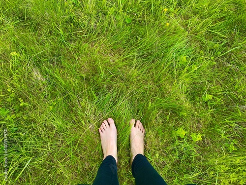 Feet in the grass, walking barefoot, healthy life 