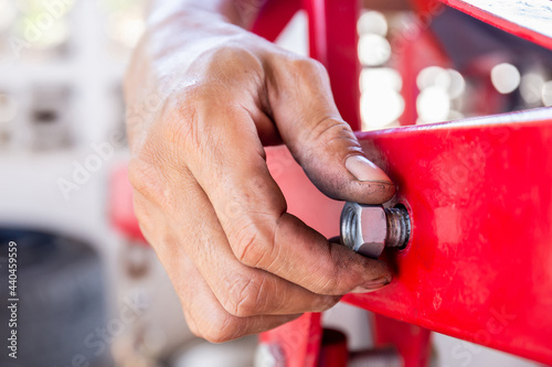 Obraz na plátně Close up of repair mechanic hands install bolts & nuts of piping, Worker's hand