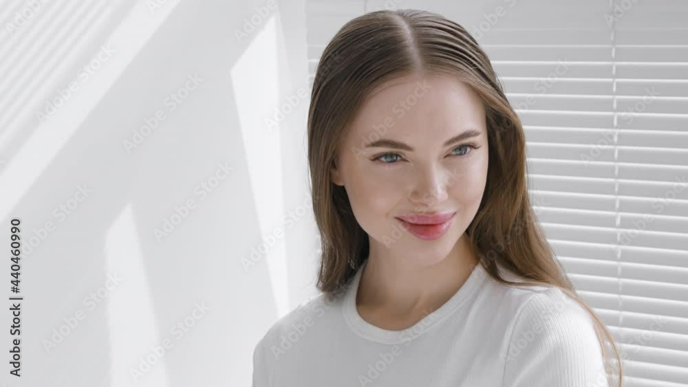 Beautiful young woman happy teeth smile face portrait looking camera, beautiful model with long brunette hair white color window Beautiful young woman happy teeth smile face portrait looking camera, beautiful model with long brunette hair white color window
