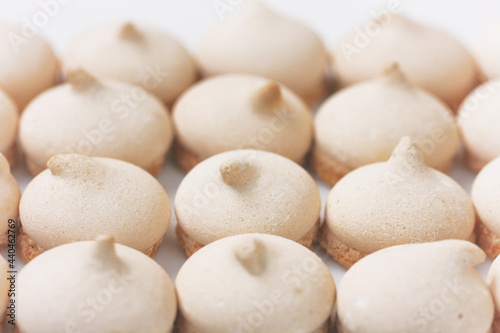 small meringue cookies  arranged in row  selective focus