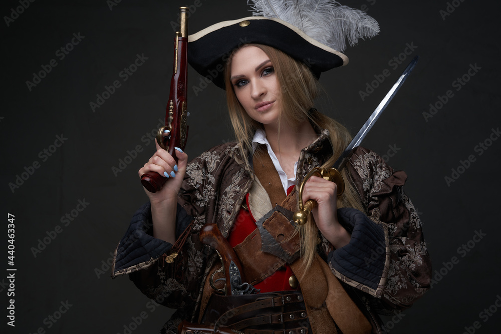 Fototapeta premium Woman buccaneer dressed in pirate suit and hat