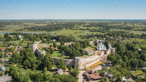 Aerial view of Izborsk fortress in Russia. Semi-ruined walls, towers and courtyards around a 14th-century fortress photo