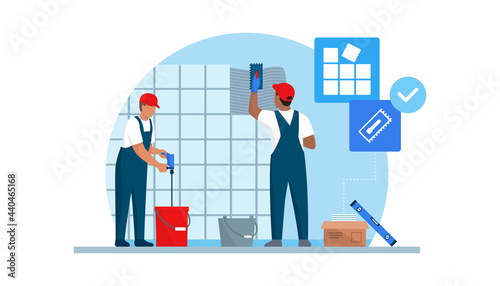 Professional tilers installing tiles on a wall